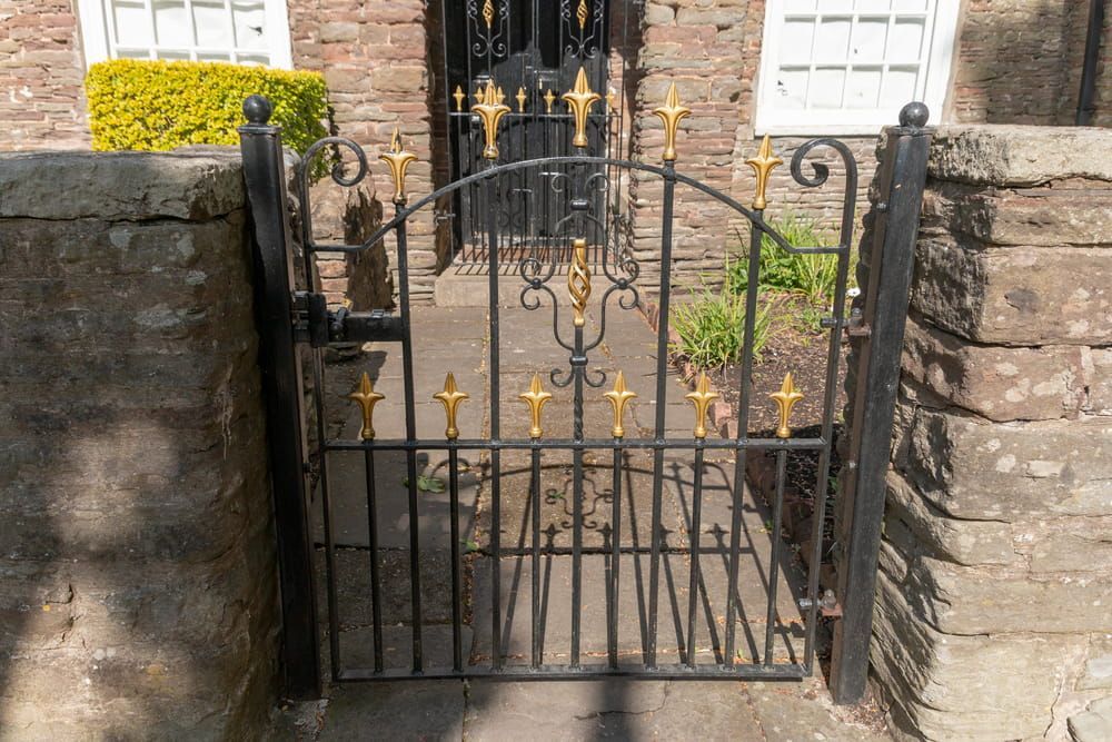 A wrought iron gate with gold crosses on it — We Do Fencing in Sunshine Acres, QLD