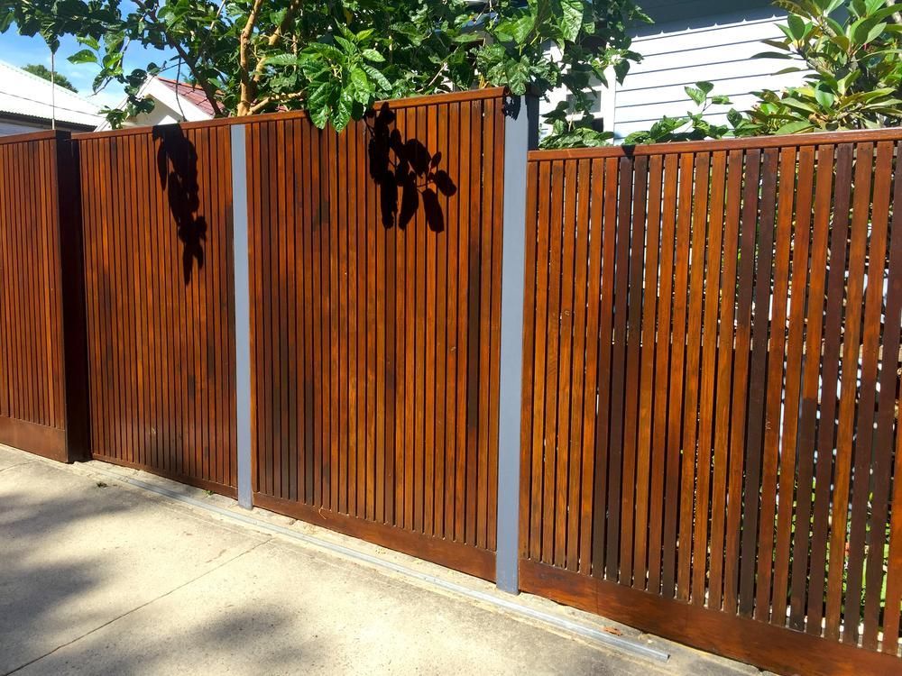 Wooden Fence With Metal Posts, Featuring Vertical Slats and Decorative Cutouts — We Do Fencing in Sunshine Acres, QLD