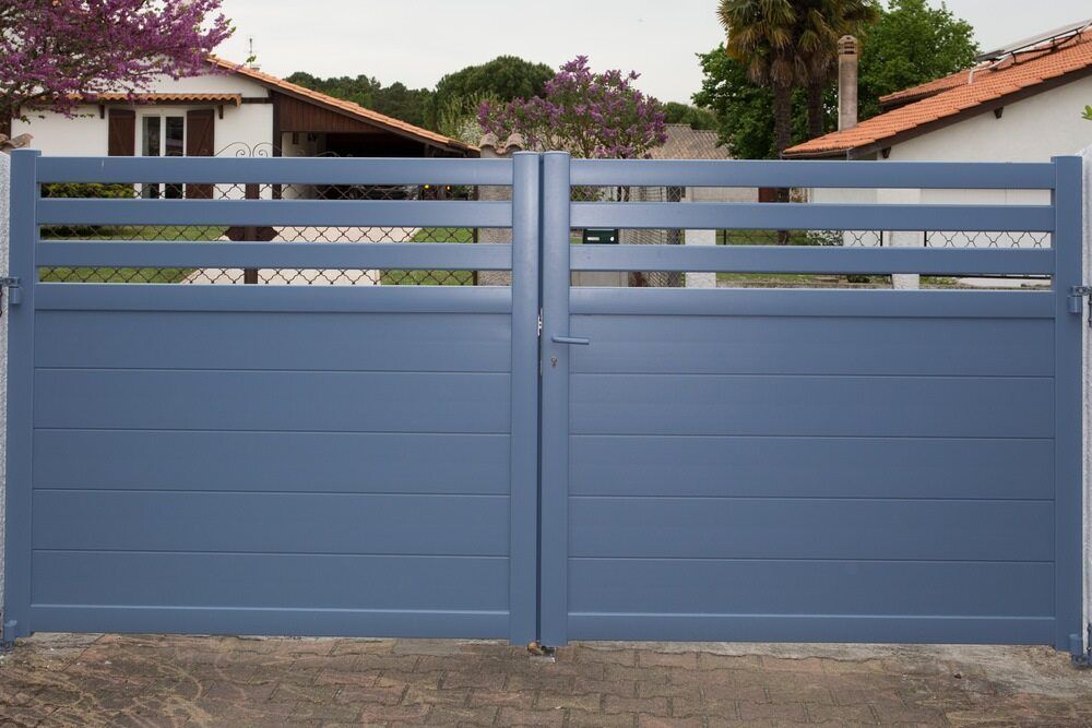 A Blue Gate is Sitting in Front of a House — We Do Fencing in Sunshine Acres, QLD