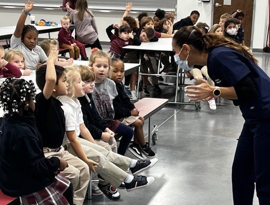 Dr. Alma teaching children in Apopka about dental health.