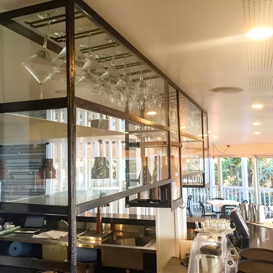 A Restaurant With A Glass Divider Between The Kitchen And Dining Area — Cape Byron Glass In Bangalow, NSW