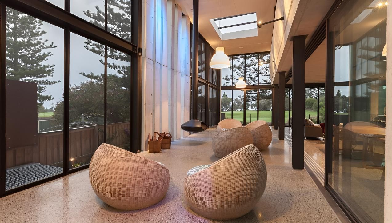 A Living Room With A Lot Of Windows And Chairs — Cape Byron Glass In Byron Bay, NSW