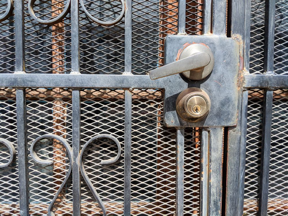 A Close Up Of A Rusty Wrought Iron Gate With A Handle — Cape Byron Glass In Byron Bay, NSW