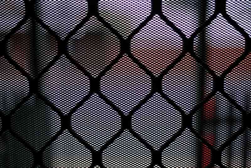 A Close Up Of A Black Mesh Fence With A Purple Background — Cape Byron Glass In Byron Bay, NSW