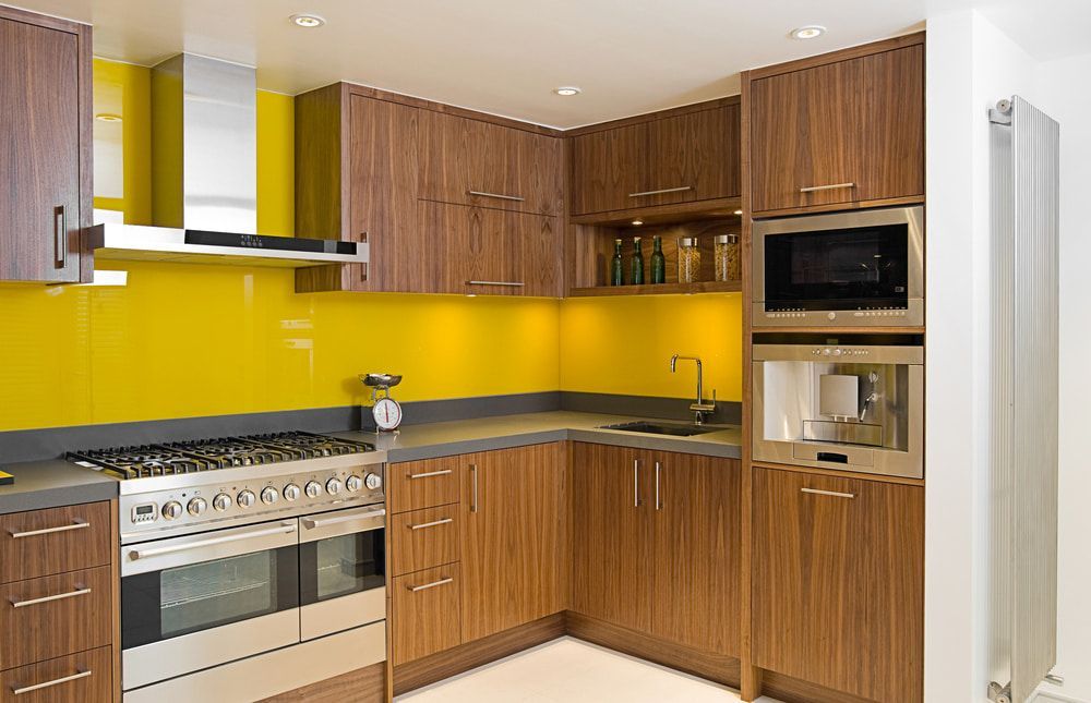 A Kitchen With Wooden Cabinets And Yellow Counter Tops — Cape Byron Glass In Byron Bay, NSW