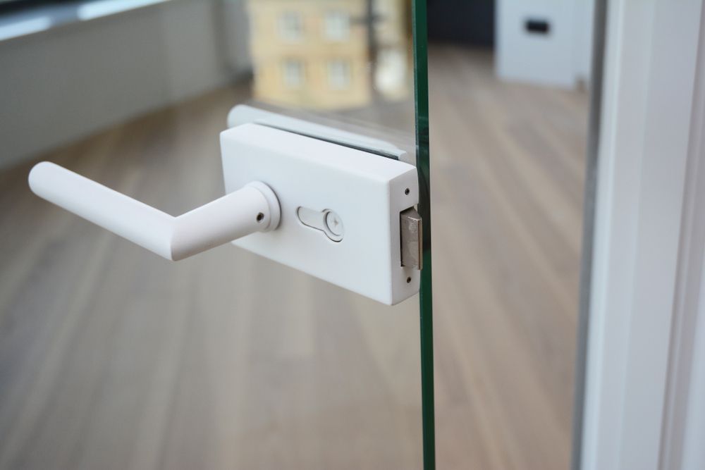 A Close Up Of A White Door Handle On A Glass Door — Cape Byron Glass In Byron Bay, NSW