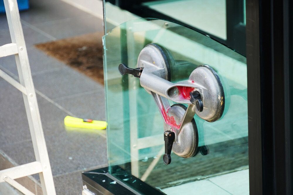 A Close Up Of A Glass Window Being Installed — Cape Byron Glass In Byron Bay, NSW