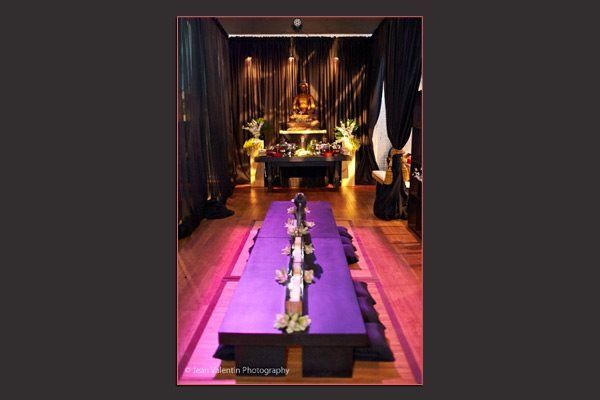 A long purple table in a dark room
