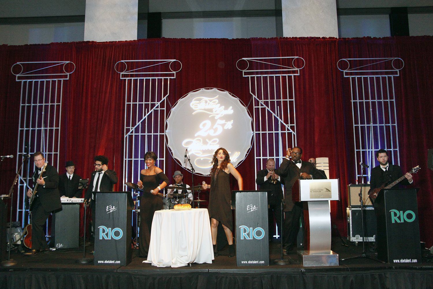 A group of people standing on a stage with the word rio on their stands