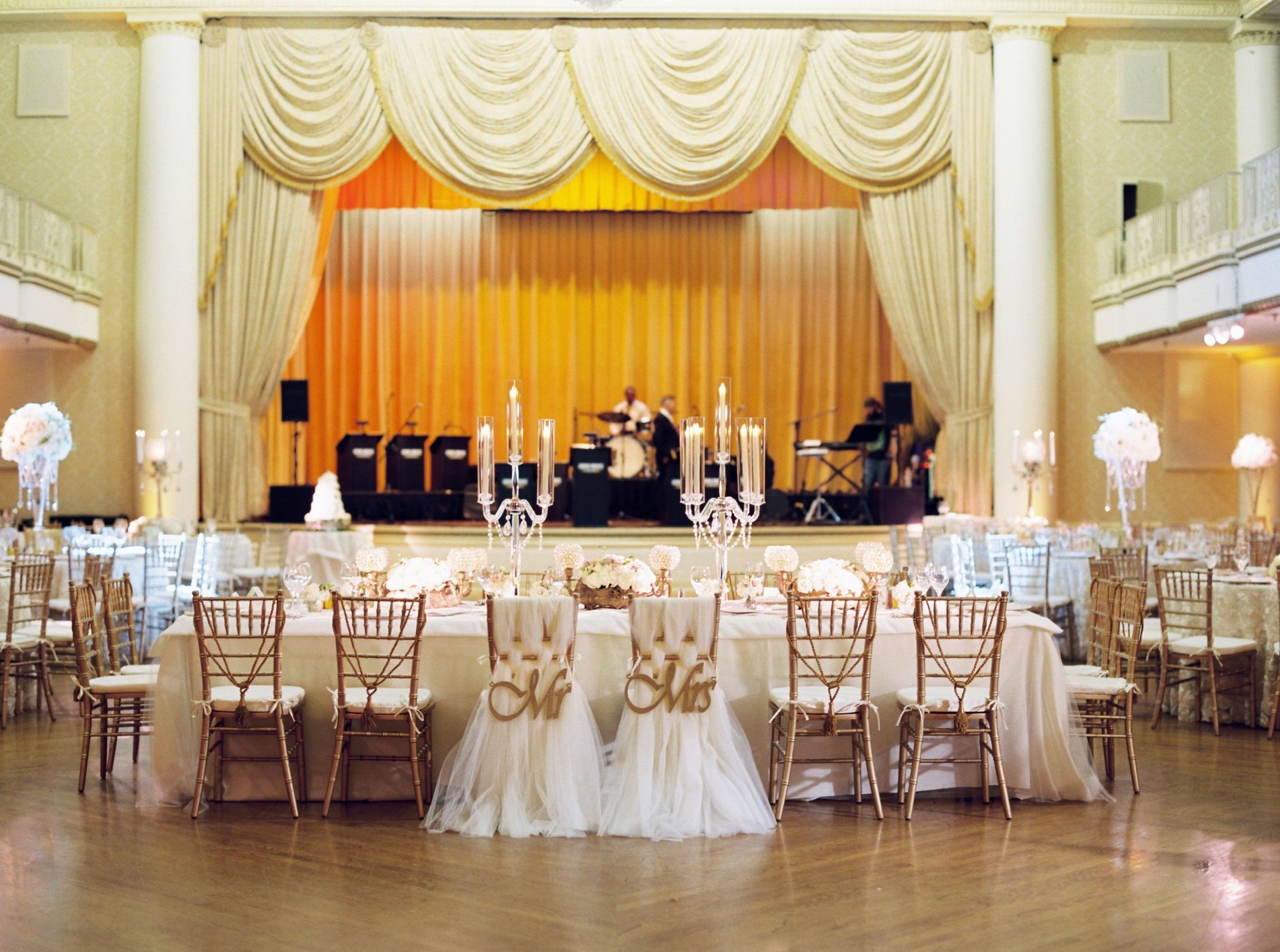 A large ballroom with tables and chairs set up for a wedding reception.