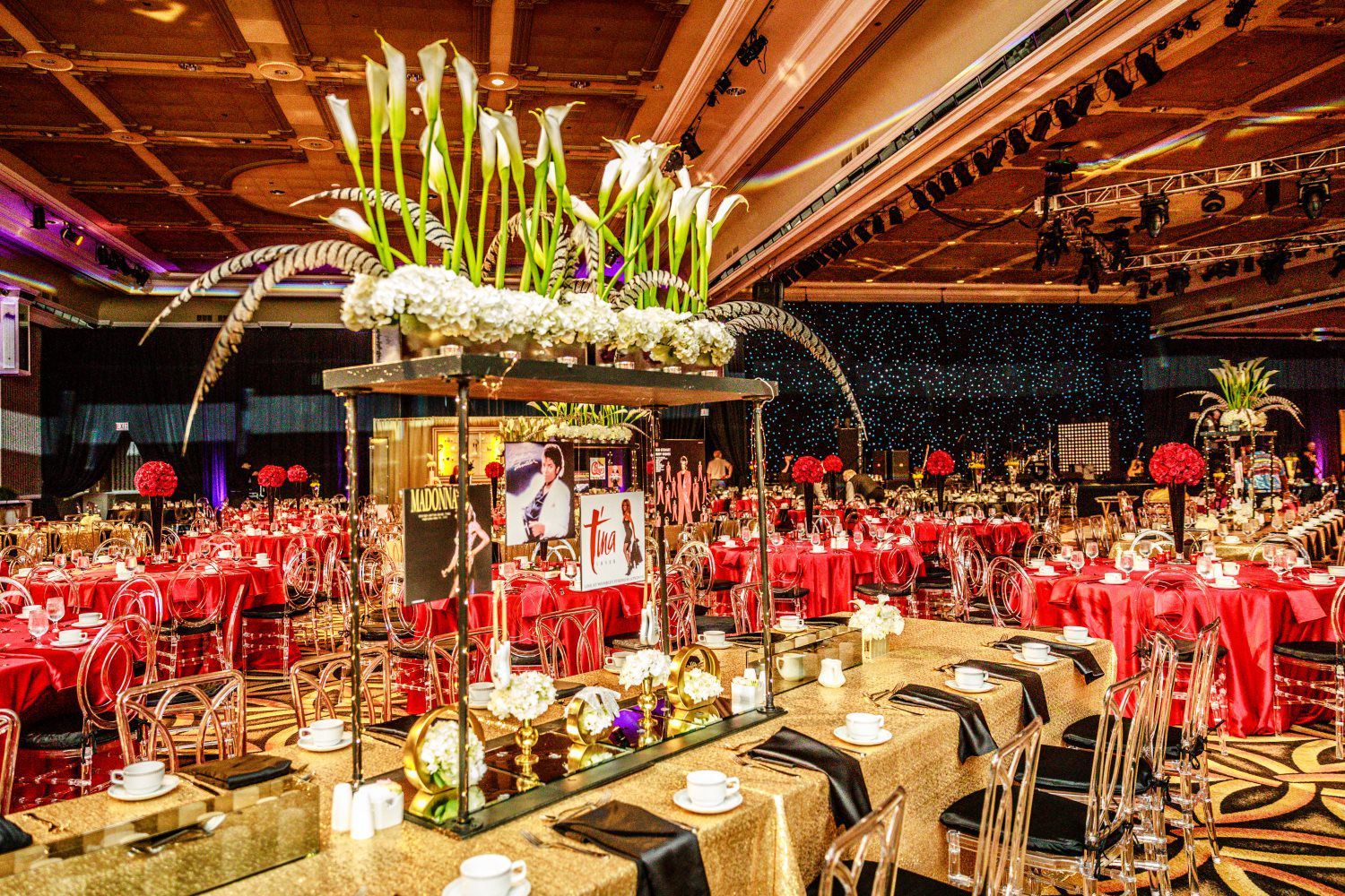 A large room with tables and chairs set up for a party.