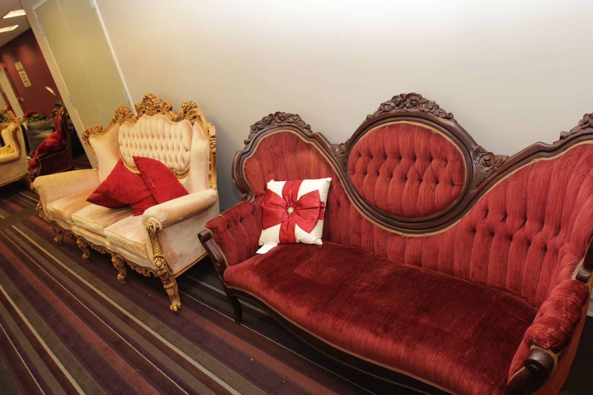 A red couch with a white bow on it