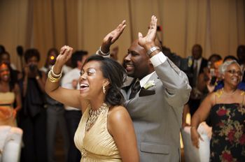 A man and a woman are dancing together at a wedding reception.