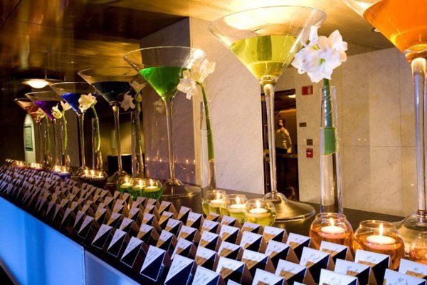 A row of martini glasses and candles on a table