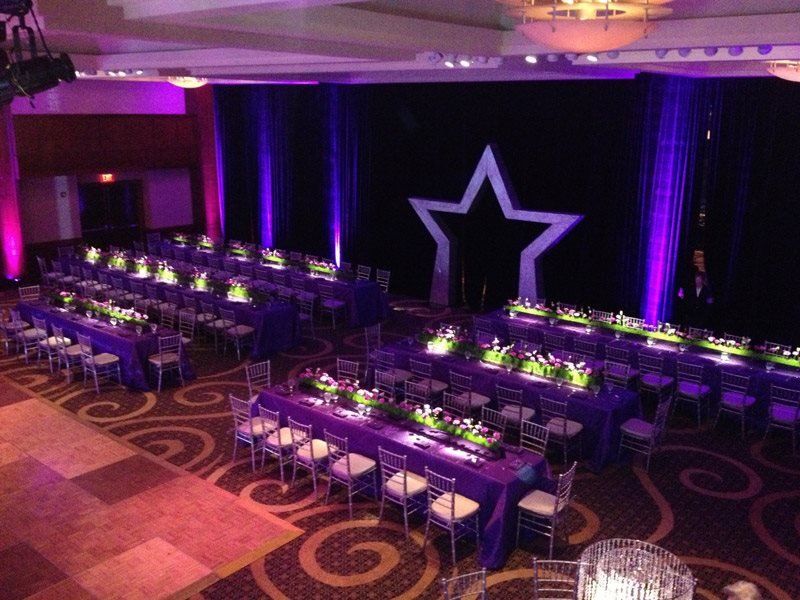 A large room with purple tables and chairs and a star on the wall