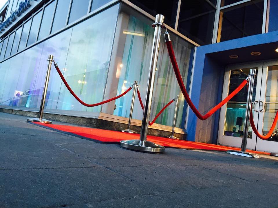 A red carpet is lined up in front of a building