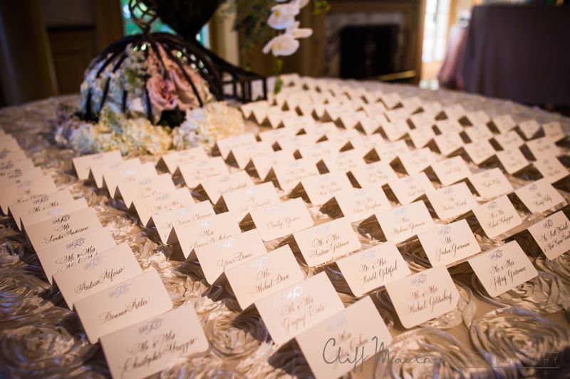 A table with a lot of place cards on it.