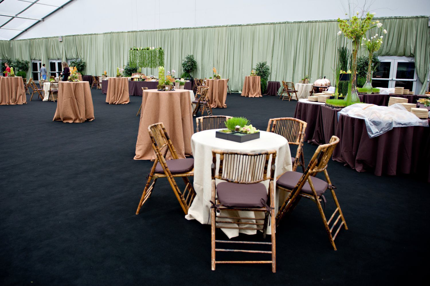 A large room with tables and chairs set up for a party