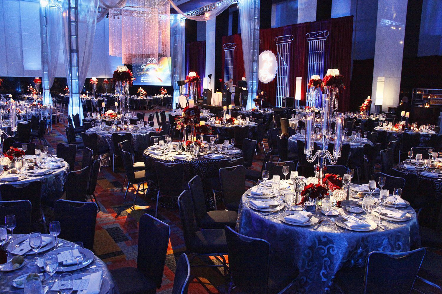 A large room with tables and chairs set up for a party