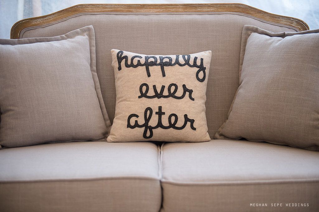 A couch with a pillow that says happy ever after