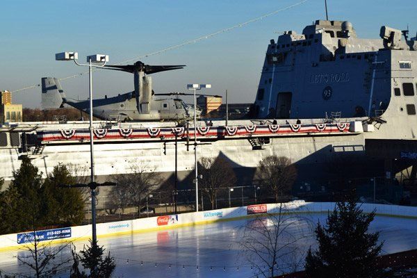 An ice rink with a large ship in the background
