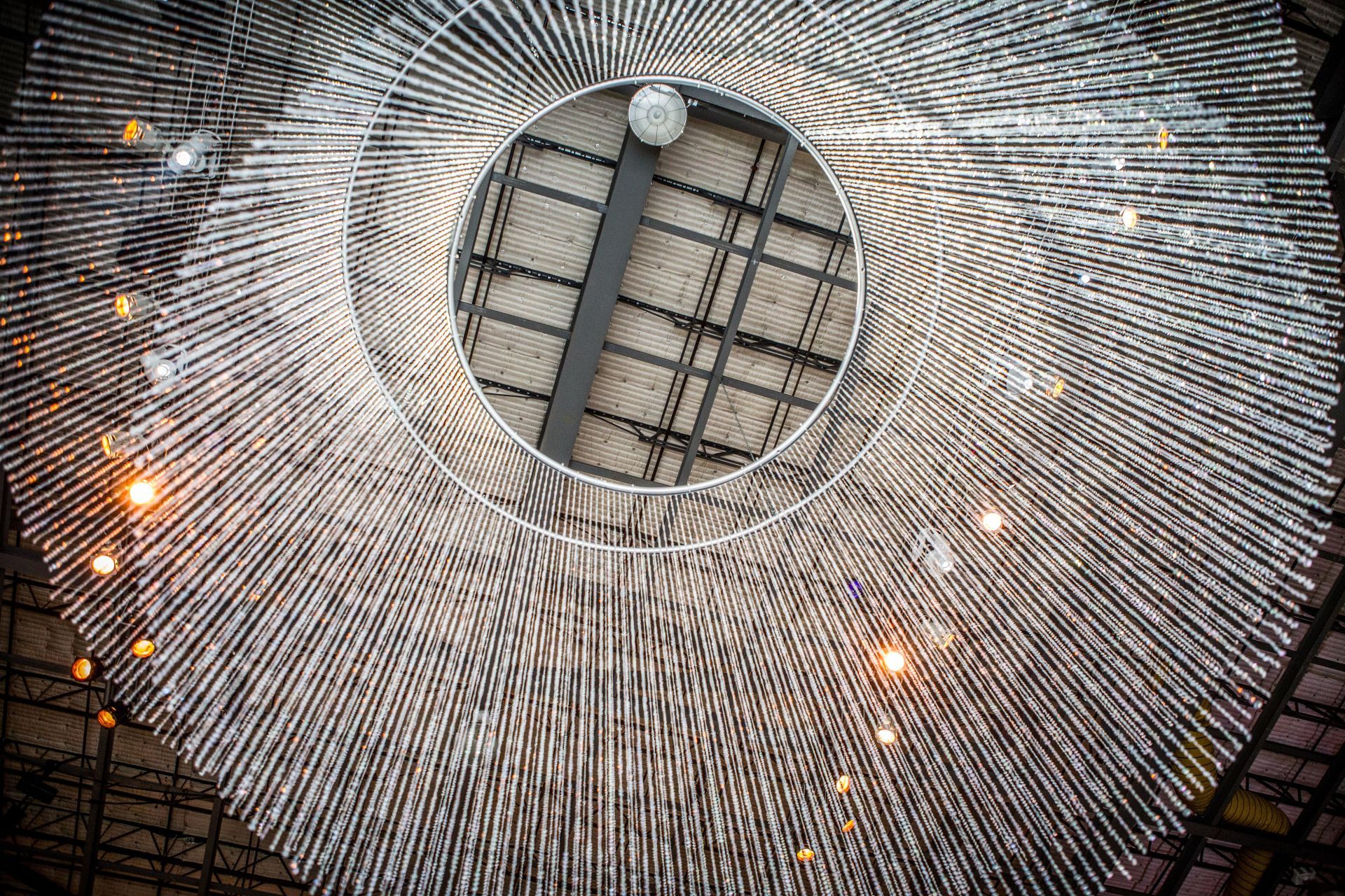 A large chandelier is hanging from the ceiling of a building.