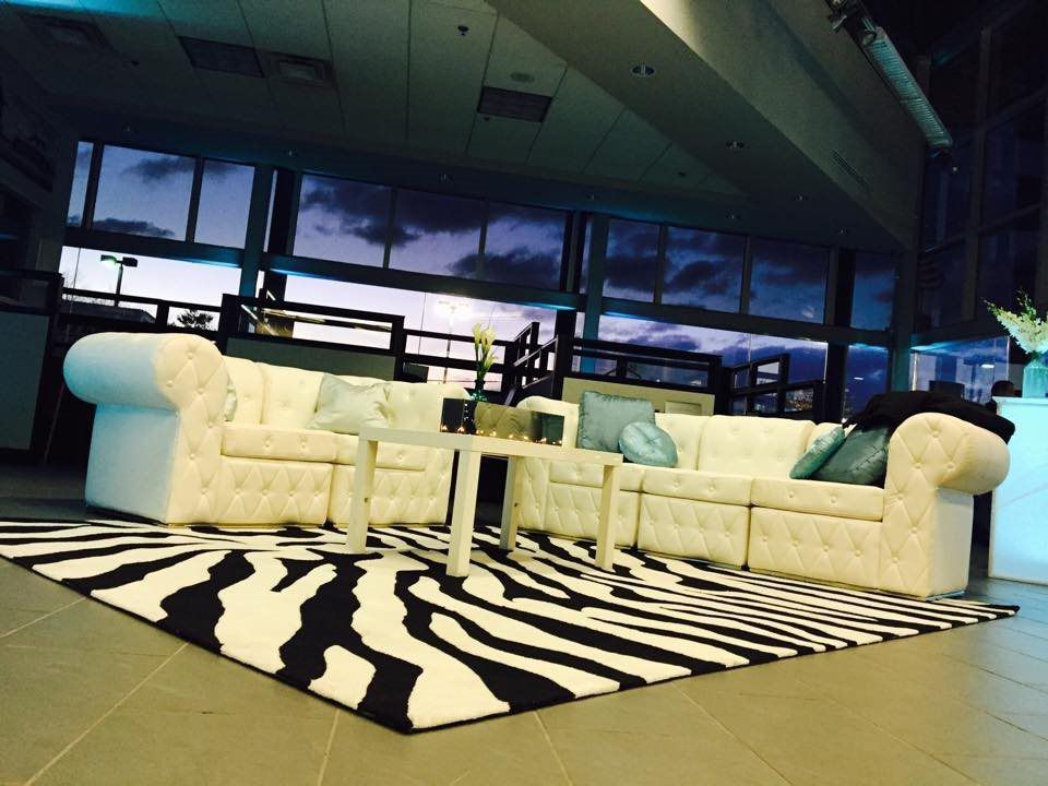 A living room with a zebra print rug and a sectional couch