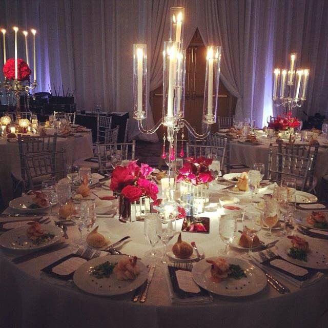 A table set for a wedding reception with candles and flowers