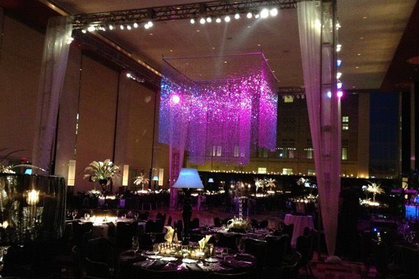 A large room with tables and purple lights on the ceiling