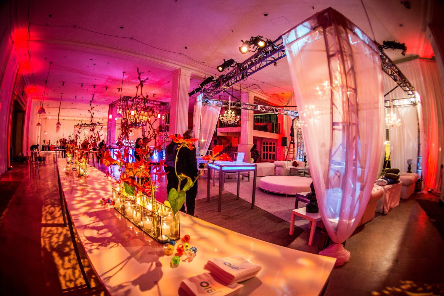 A large room decorated for a party with tables and chairs.