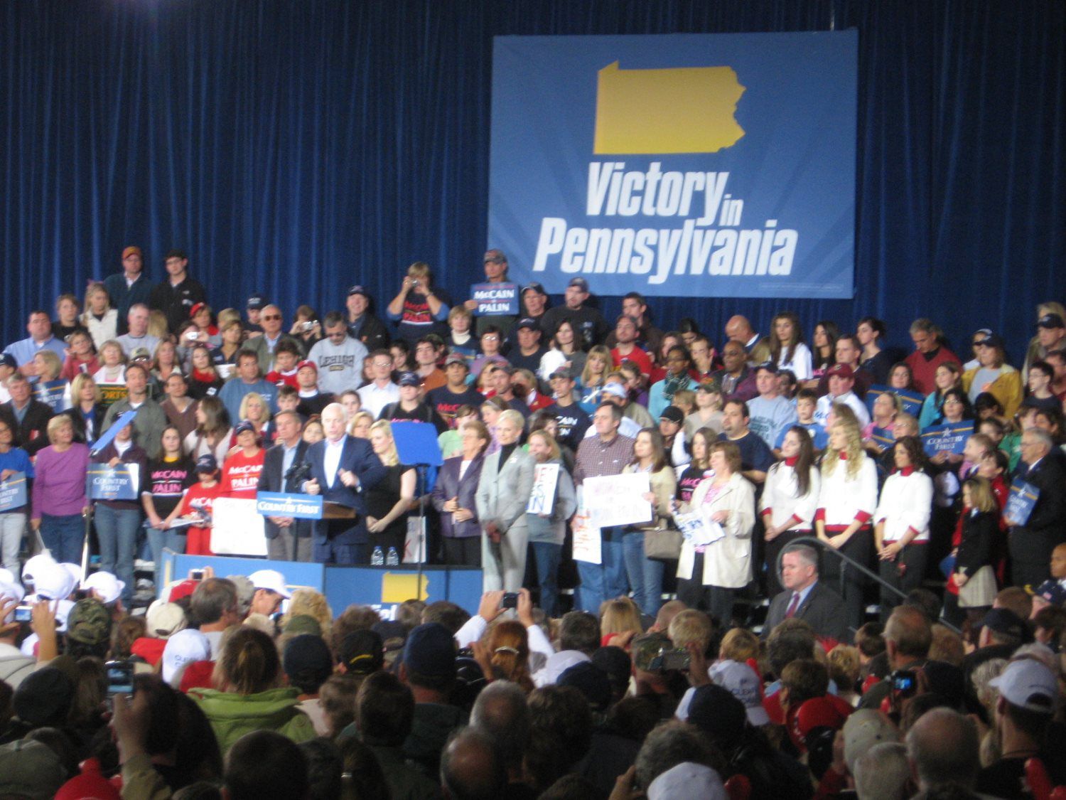 A large crowd gathered in front of a sign that says victory pennsylvania