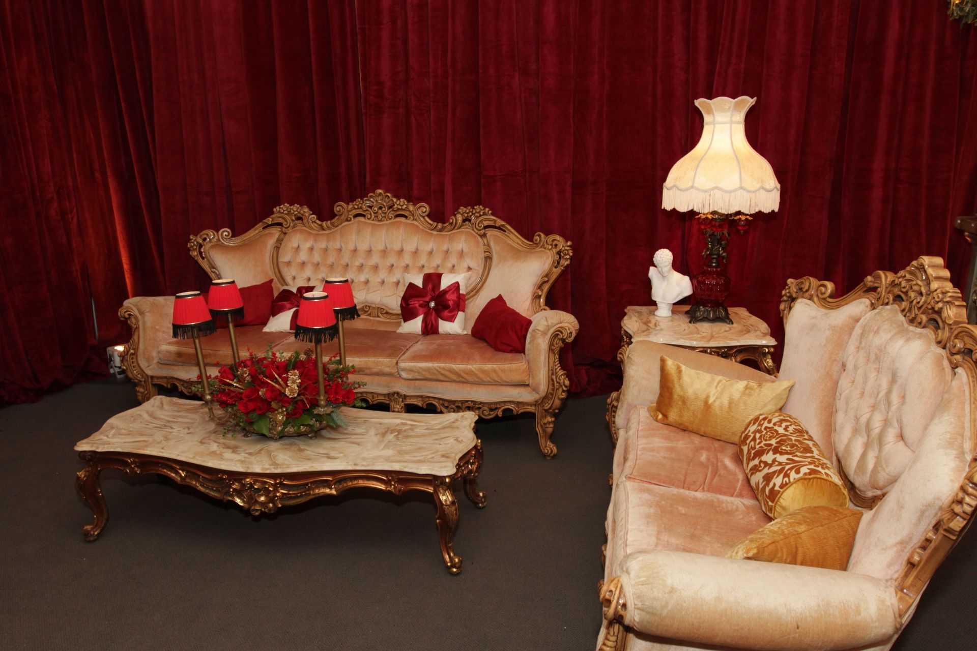 A living room with a couch , coffee table and lamp