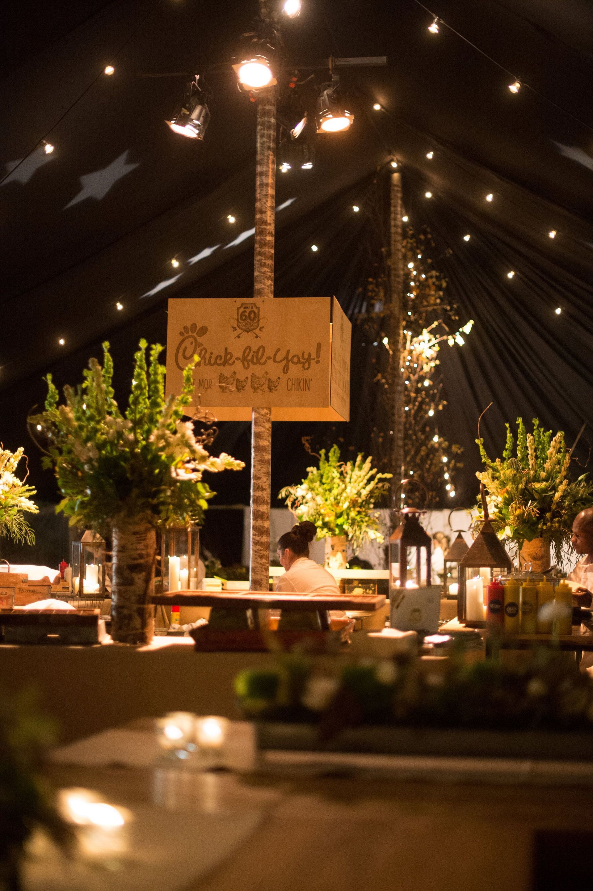 A sign on a pole in a dark room says happy birthday