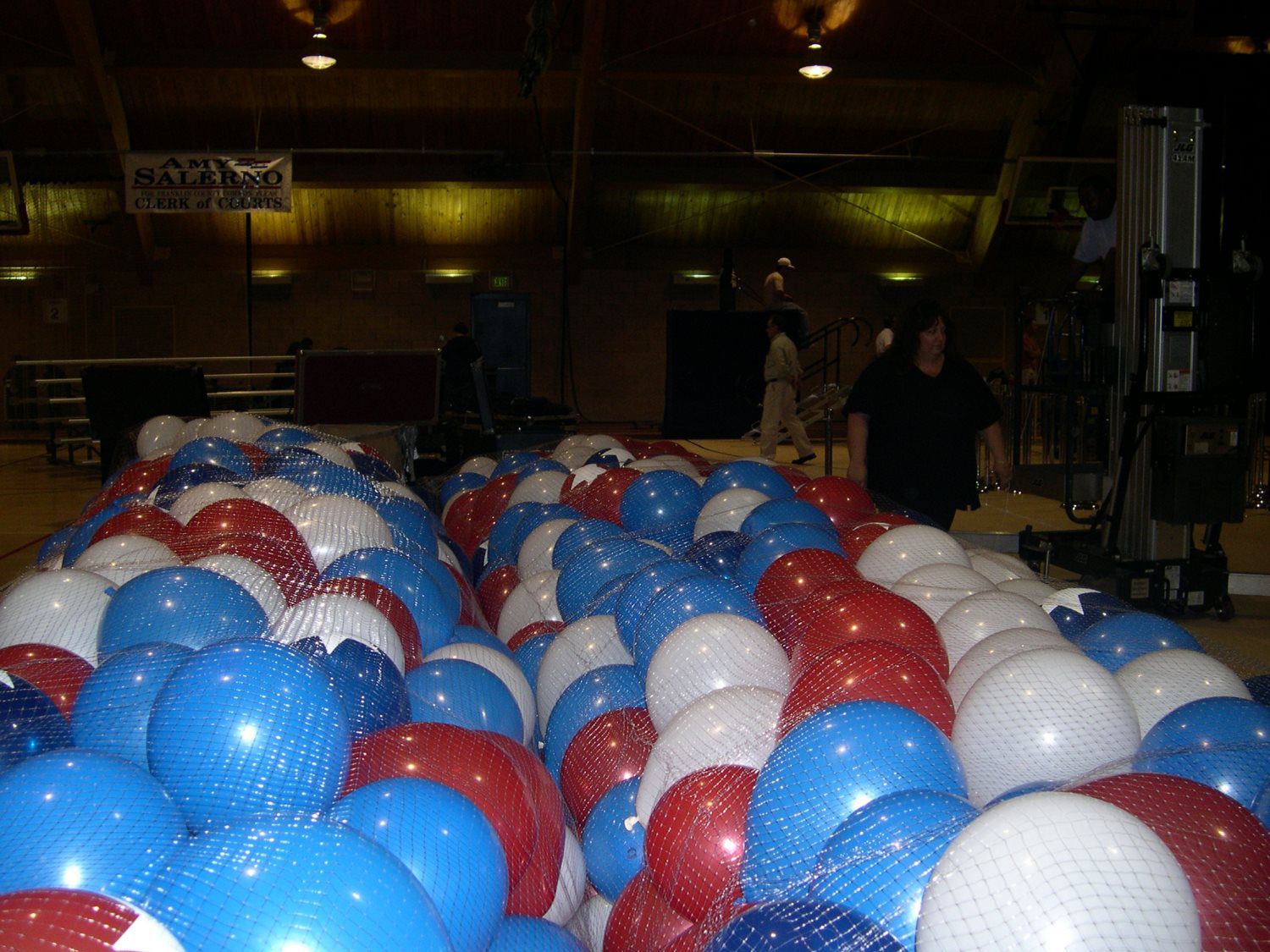 A large pile of red white and blue balloons