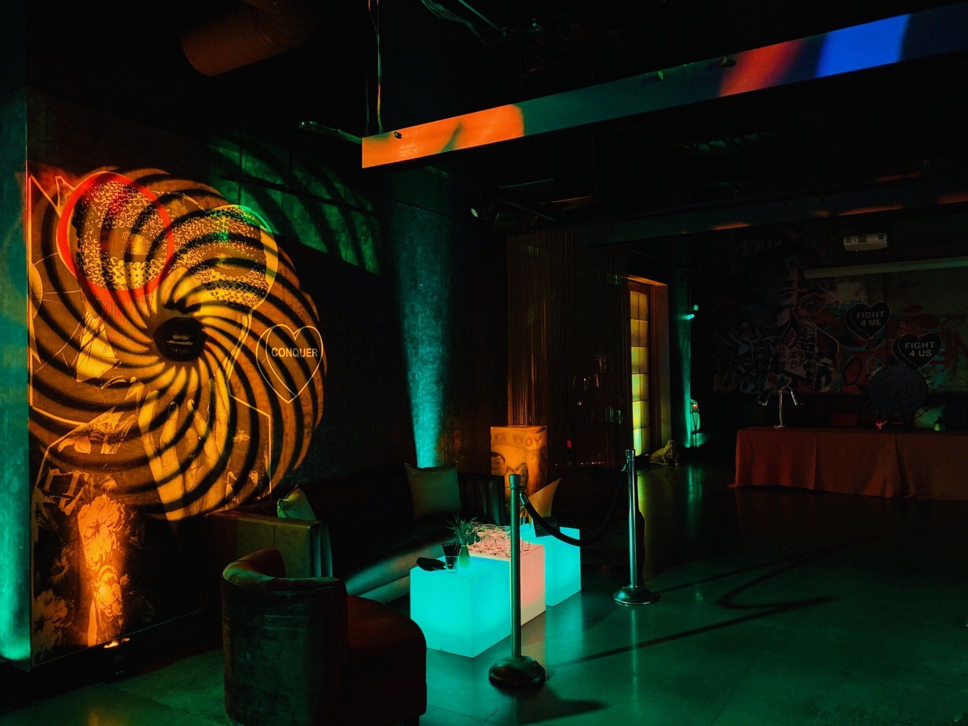 A room with a lot of lights on it and a swirl on the wall.