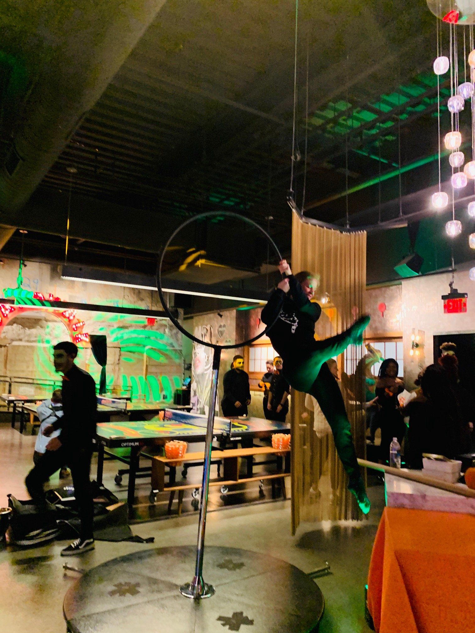 A person is doing aerial acrobatics in a restaurant.