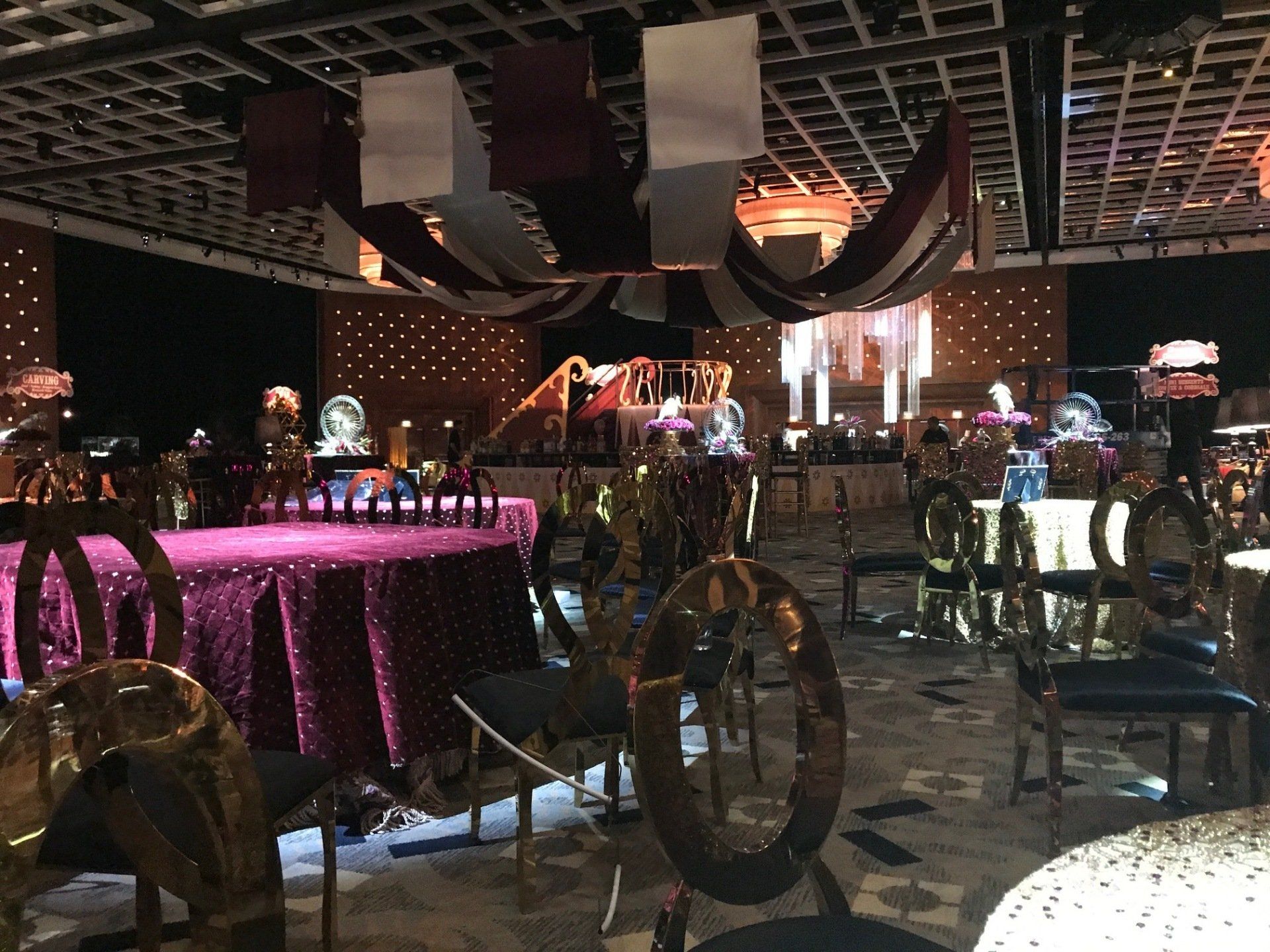 A large room with tables and chairs set up for a party