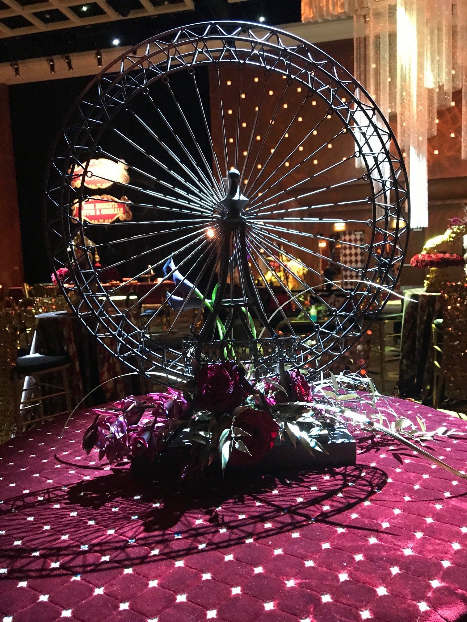 A ferris wheel sitting on top of a purple carpet