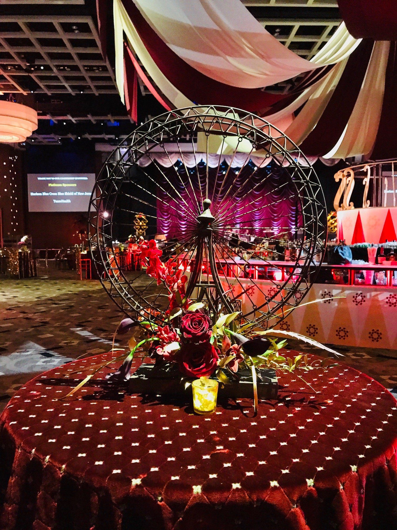 A ferris wheel is sitting on top of a table in a large room.
