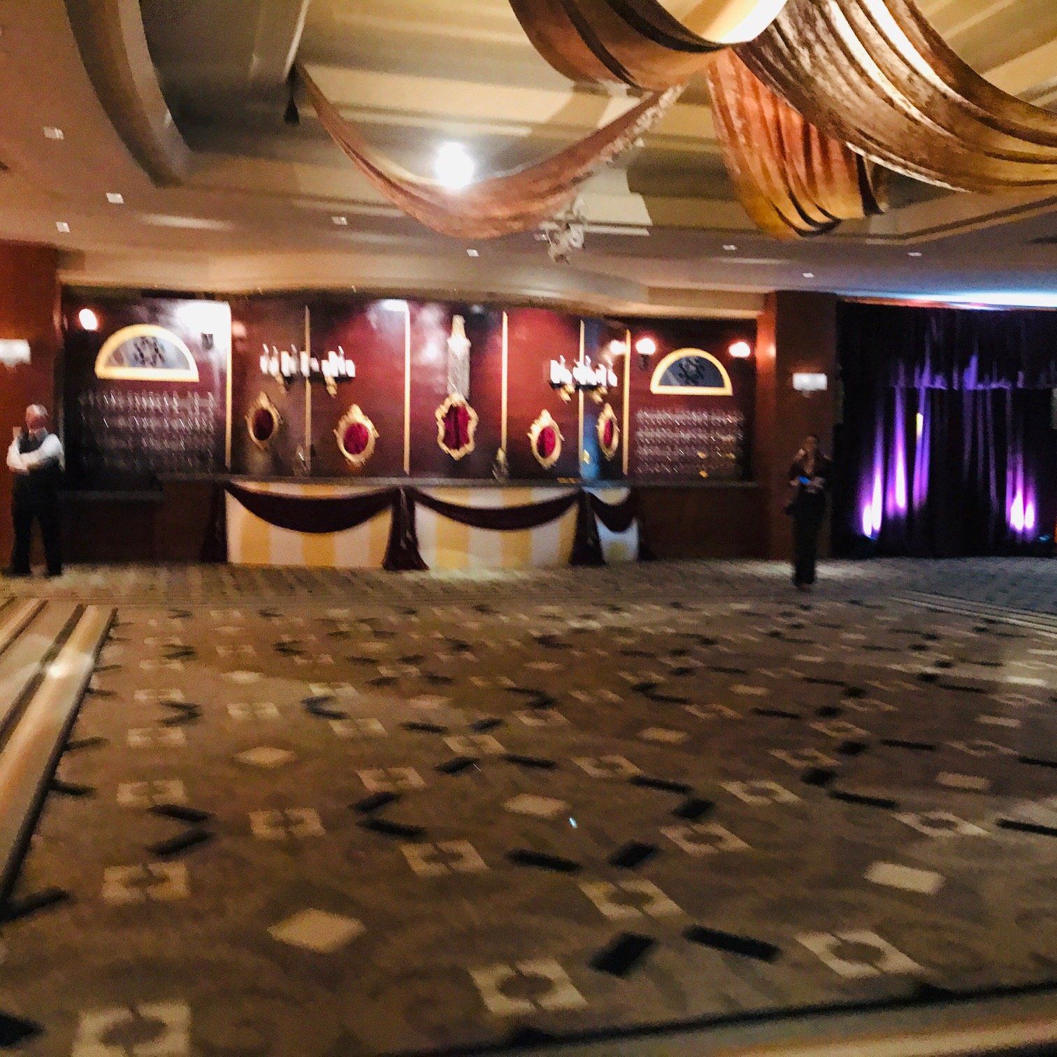 A large room with a carpet and a few tables