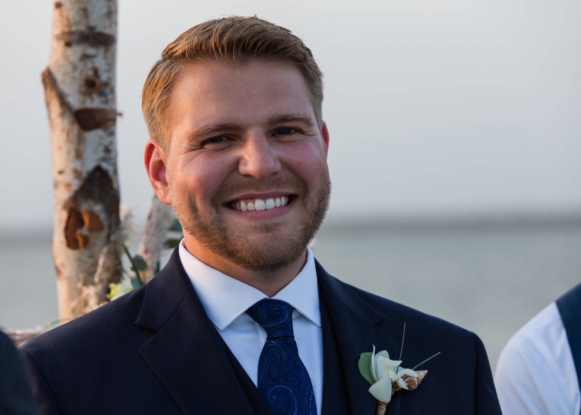 A man in a suit and tie is smiling for the camera.