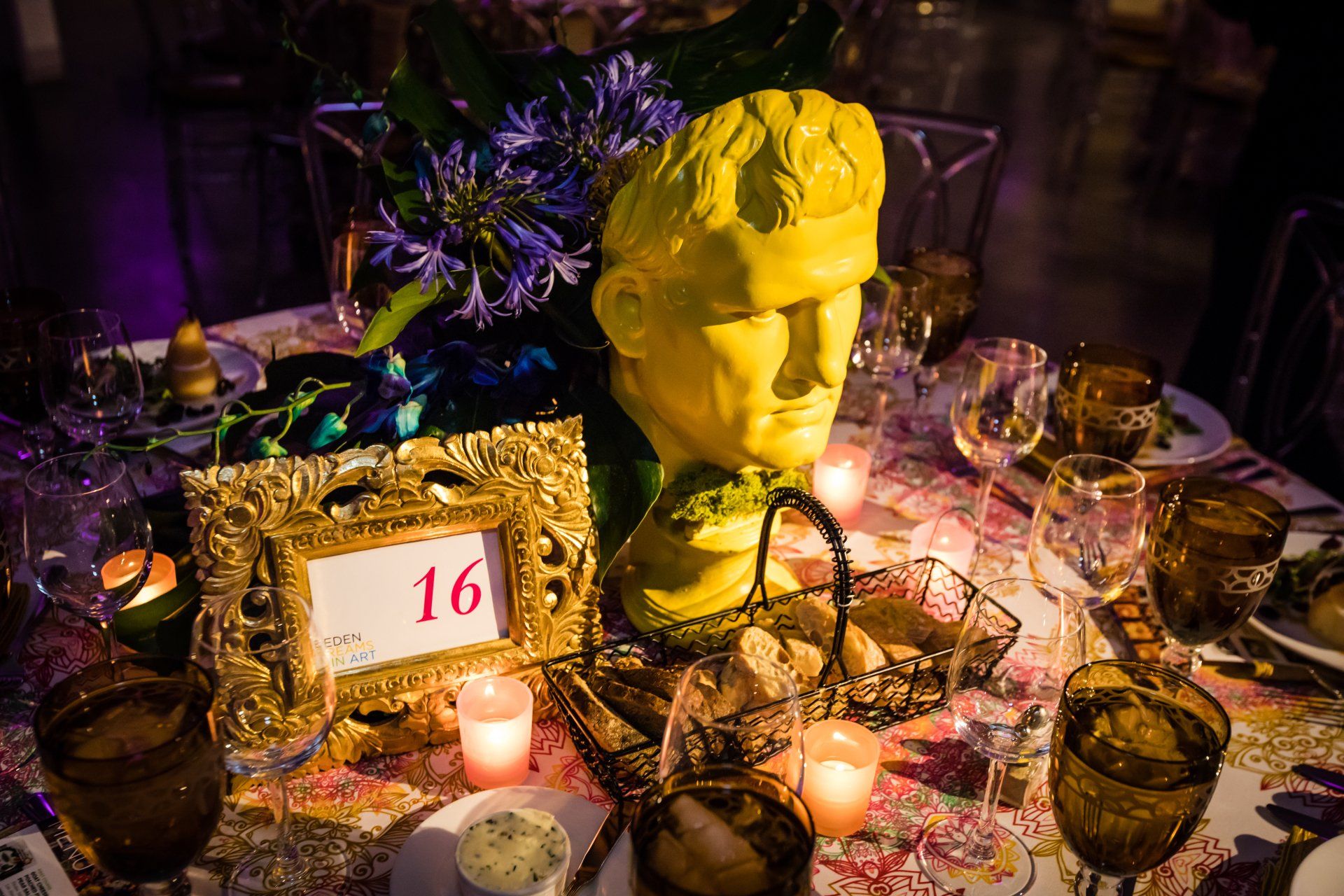 A table with a statue of a man on it and a table number 16.