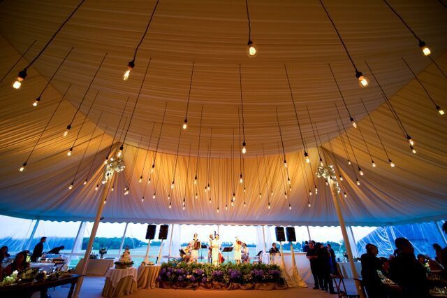 A large tent with lots of lights hanging from the ceiling.
