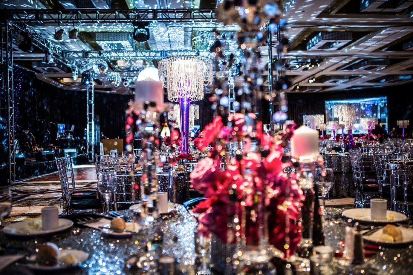 A large room with tables and chairs set up for a party.