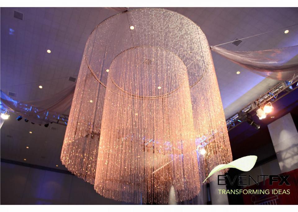 A large chandelier is hanging from the ceiling in a room