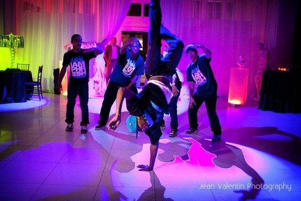 A group of people are doing a handstand on a dance floor.