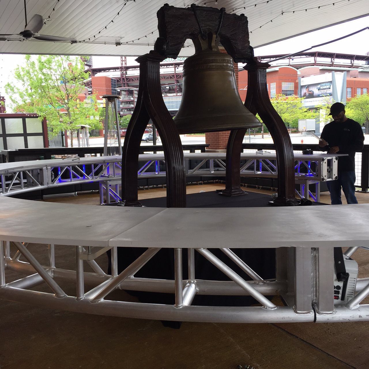 A large bell is hanging from a metal structure