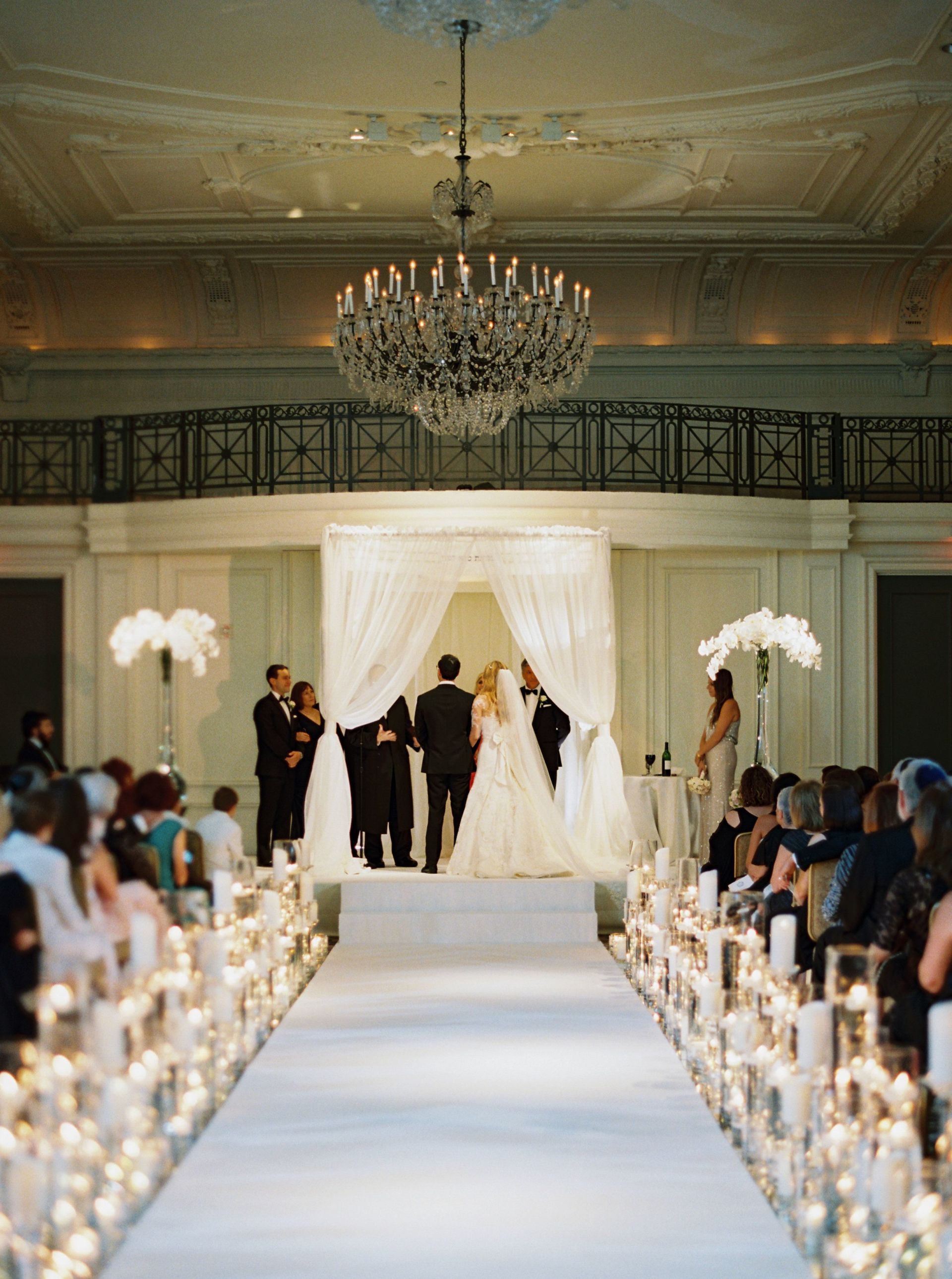 A bride and groom are walking down the aisle at their wedding ceremony.