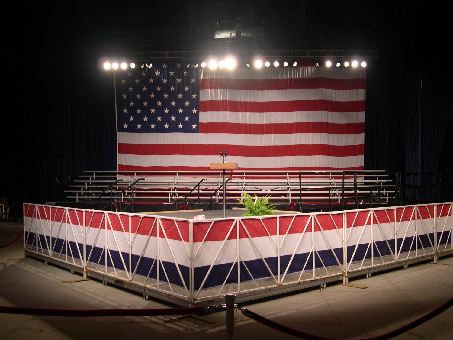 A stage with a large american flag behind it