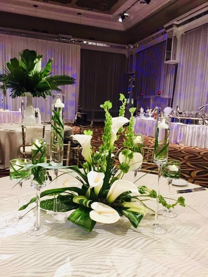 A table with flowers and candles on it in a room.